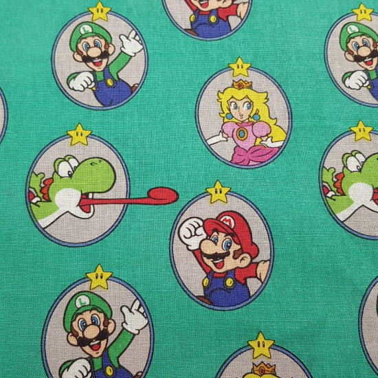 Cotton Super Mario Round Frames fabric - Licensed cotton fabric with drawings of the characters from the video game Super Mario inside round frames on a green background. The fabric is 110cm wide and its composition is 100% cotton.