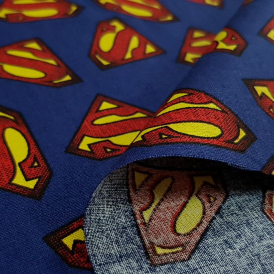 Cotton Superman Logos Blue fabric - Cotton fabric with drawings of logos of the superhero Superman on a blue background. The fabric is 110cm wide and its composition 100% cotton