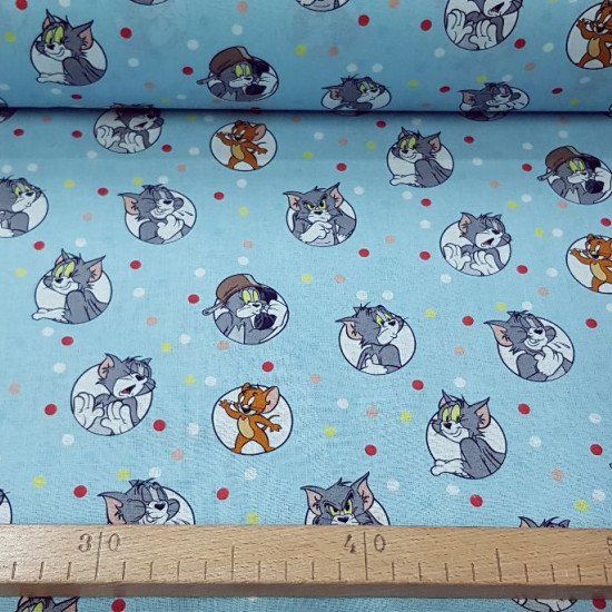 Tom Jerry Cotton Polka Dots fabric - Licensed cotton fabric with drawings of the classic characters Tom and Jerry on a blue background with colored polka dots. The fabric is 140cm wide and its composition 100% cotton