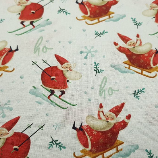 Cotton Christmas Santa Claus Sledges fabric - Christmas cotton fabric with drawings of Santa Claus skiing and also climbed in his sleigh on a white background with snowflakes and letters ho ho ho. The fabric is 150cm wide and its composition 100% cotton.
