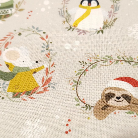 Cotton Christmas Animals Snowmen fabric - Organic cotton poplin fabric with drawings of forest animals and snowmen with scarves and hats inside floral circles on a light background with snowflakes. The fabric is 150cm wide and its composition is 100% cott
