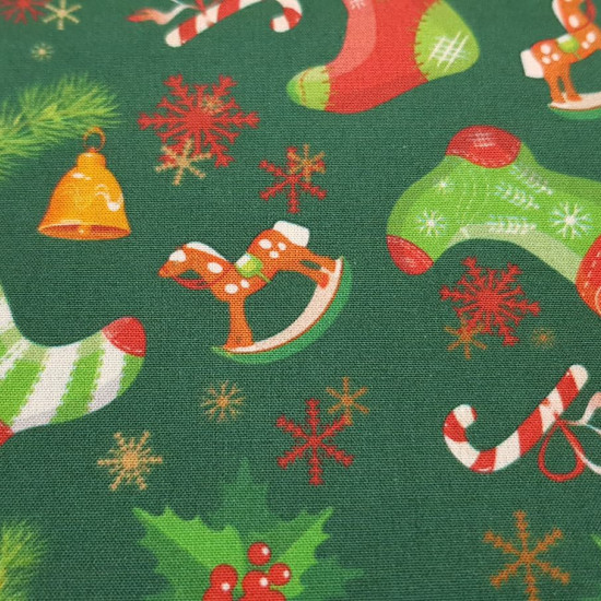 Cotton Christmas Socks Ice Flakes fabric - Cotton poplin fabric with Christmas decoration with drawings of socks, ice flakes, bells, wooden horses... on two color backgrounds to choose from. The fabric is 140cm wide and its composition is 100% cotton.