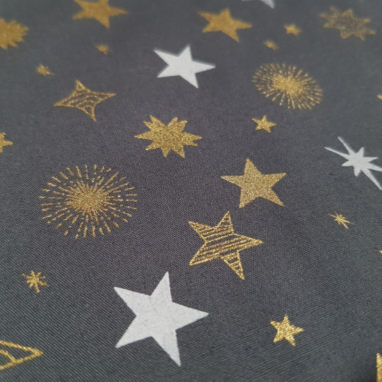 Algodón Navidad Estrellas Fondo Gris - Tela de popelín algodón de temática navideña donde aparecen estrellas doradas con brillo y blancas sobre un fondo de color gris.  La tela mide 140cm de ancho y su composición 1