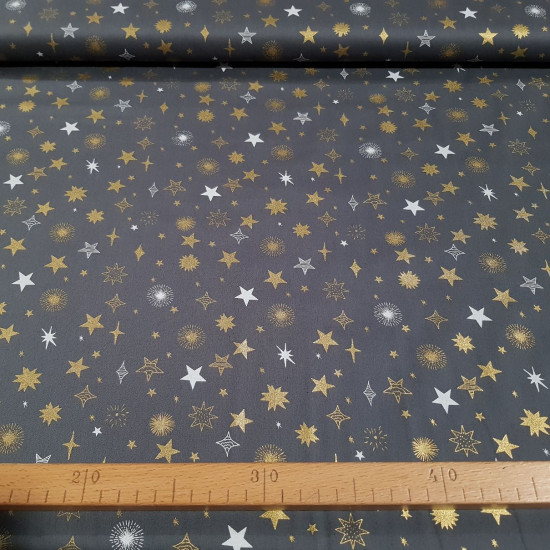 Cotton Christmas Stars Gray Background fabric - Christmas-themed cotton poplin fabric with glittery gold and white stars on a gray background. The fabric measures 140cm wide and its composition is 100% cotton.