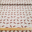 Cotton Christmas Caga Tió Candies fabric - Christmas poplin cotton fabric with drawings of the caga tió on a rustic background with white stars and candies such as lollipops, canes... The fabric is 150cm wide and its composition is 100% cotton.