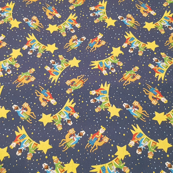 Christmas Cotton Three Wise Men Star fabric - Poplin cotton fabric with Christmas drawings of the Three Wise Men guided by the star of Bethlehem on a dark blue background with stars. The fabric is 150cm wide and its composition is 100% cotton.