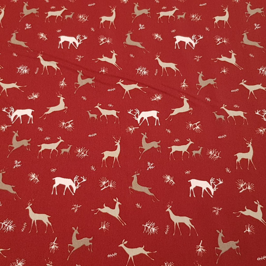 Algodón Navidad Renos Rojo - Tela de popelín algodón navidad con dibujos de renos en varios tamaños sobre un fondo de color rojo. La tela mide 150cm de ancho y su composición 100% algodón.