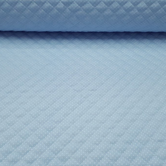Quilted Pique White Polka Dot Light Blue Background fabric - Light blue quilted piqué fabric with small white dots. Ideal fabric for children's projects and especially baby accessories such as bags, changing tables, diaper envelopes ... The fabric is 150c