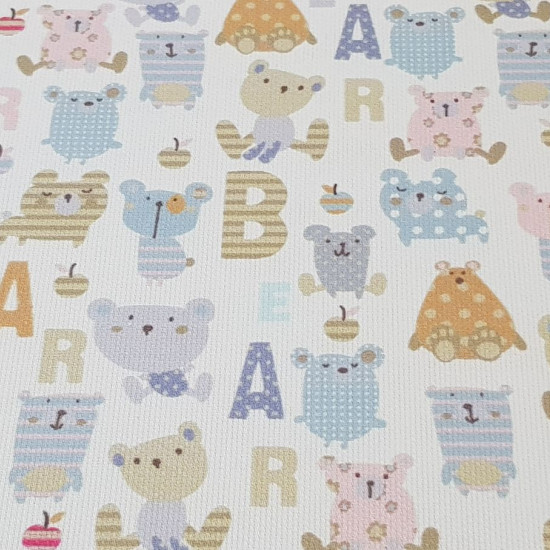 Pique Bears Letters Patchwork fabric - Children's themed cotton pique fabric with drawings of colored bears with patchwork drawings and letters where the words 'bear' appear The fabric is 150cm wide and its composition is 100% cotton.