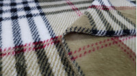Coral Fleece Scottish Check Beige fabric - Coral fleece fabric with a Burberry-style Scottish check pattern, in beige and brown tones. Ideal for blanket and other confections. The fabric is 150cm wide and its composition is 100% polyester.