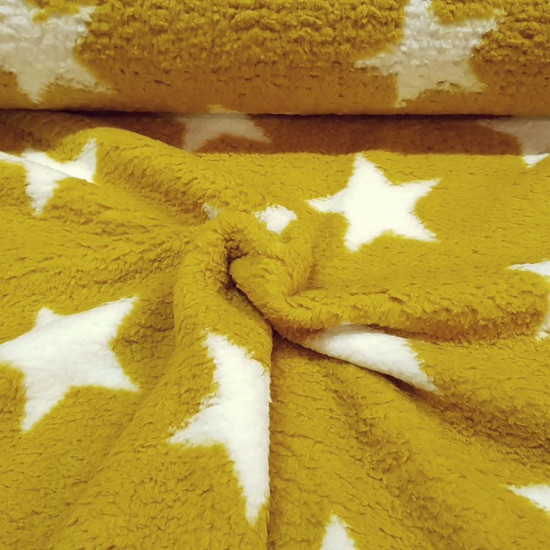 Sherpa Fleece Stars fabric - Sherpa fleece fabric with drawings of white stars on an ocher background. Sherpa fabric has a very soft touch and reminds us of a sheepskin. The fabric is 150cm wide and its composition is 100% polyester.