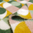 Coral Fleece Geometric Shapes fabric - Coral fleece fabric very soft to the touch with geometric patterns of squares and circles in shades of mustard, green and pink. The fabric is 150cm wide and its composition is 100% polyester.
