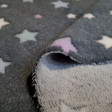 Coral Fleece Stars Jacquard fabric - Coral fleece fabric with colored star designs with jacquard effect (relief) on a gray background. The fabric is 150cm wide and its composition is 100% polyester.