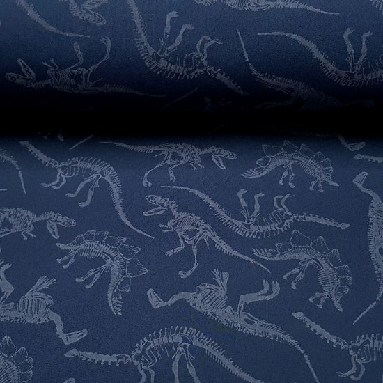 Tela Softshell Dinosaurios Brilla en la Oscuridad - Tela Softshell con dibujos de esqueletos de dinosaurio, que se ilumina en la oscuridad. El color del fondo es un azul oscuro. La tela Softshell es una tela funcional que se compone de 3 capas, la capa ex
