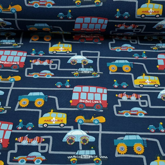 Cotton Jersey Traffic City Blue fabric - Cotton jersey fabric with drawings of cars, buses, police cars, firecars... on gray lines simulating the traffic of a city on a dark blue background. The fabric measures 150cm wide and its composition 95% cotton - 