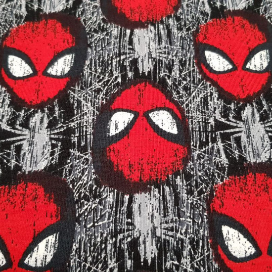 Tela Punto Algodón Spiderman Máscara - Tela de punto algodón licencia con dibujos de la máscara de Spiderman y telarañas formando un mosaico. La tela mide 150cm de ancho y su composición 92% algodón – 8% elastano