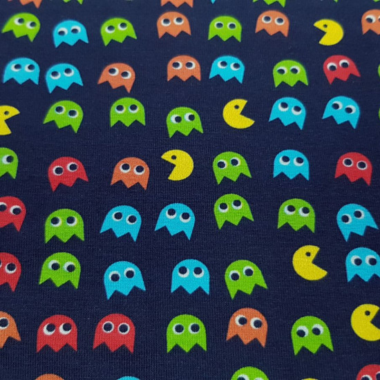 Cotton Jersey Pacman Videogame fabric - Cotton jersey fabric with drawings of the Pacman video game on a navy blue background. The fabric is 150cm wide and its composition is 94% cotton - 6% elastane.