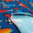 Cotton Jersey Space Toy Guns fabric - Very funny digital print cotton jersey fabric with drawings of space toy guns on a blue background. The fabric is 150cm wide and its composition is 94% cotton - 6% elastane.