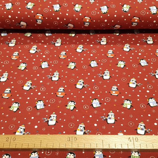 Cotton Jersey Penguins Christmas fabric - Cotton jersey fabric with very funny drawings of penguins with hats on a red background with Christmas motifs. The fabric is 150cm wide and its composition is 95% cotton - 5% elastane.