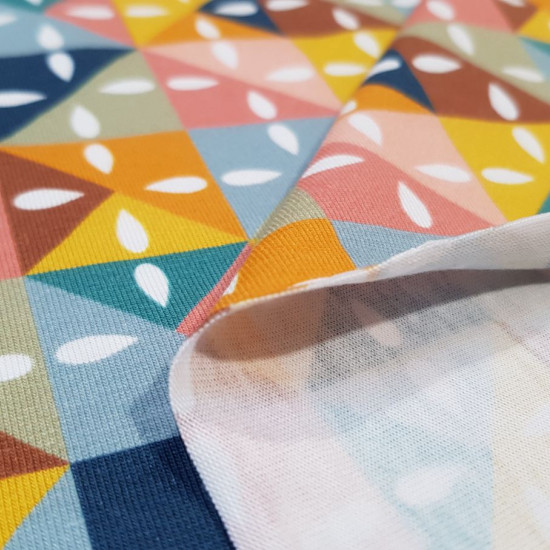 Cotton Jersey Geometric Shapes Jam fabric - Organic cotton jersey fabric with colorful geometric drawings. The fabric is 150cm wide and its composition is 95% cotton - 5% elastane.