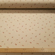Cotton Jersey Little Flowers Beige Background fabric - Cotton jersey fabric with floral drawings of small scattered flowers in rust, orange and white tones on a beige/sand background. The fabric is 145cm wide and its composition is 95% cotton - 5% elastan
