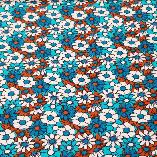 Cotton Jersey Flowers Daisies fabric - Cotton jersey fabric with drawings of daisy flowers forming a mosaic in shades of blue and brown. The fabric is 150cm wide and its composition is 95% cotton - 5% elastane.