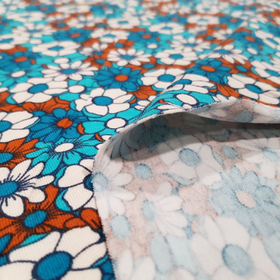 Cotton Jersey Flowers Daisies fabric - Cotton jersey fabric with drawings of daisy flowers forming a mosaic in shades of blue and brown. The fabric is 150cm wide and its composition is 95% cotton - 5% elastane.