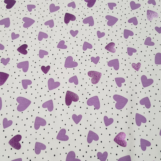Punto Camiseta Corazones Foil - Tela de punto algodón tipo camiseta con dibujos de corazones de color lila y algunos de ellos efecto brillante (foil) y topitos negros diminutos sobre un fondo blanco. La tela mide 150cm de ancho y su composic