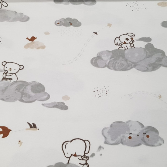 Cotton Jersey Koalas Clouds fabric - Cotton jersey fabric with drawings of koalas, elephants, bunnies and bears on clouds on a white background. The fabric measures 140cm wide and its composition is 94% cotton – 6% elastane.