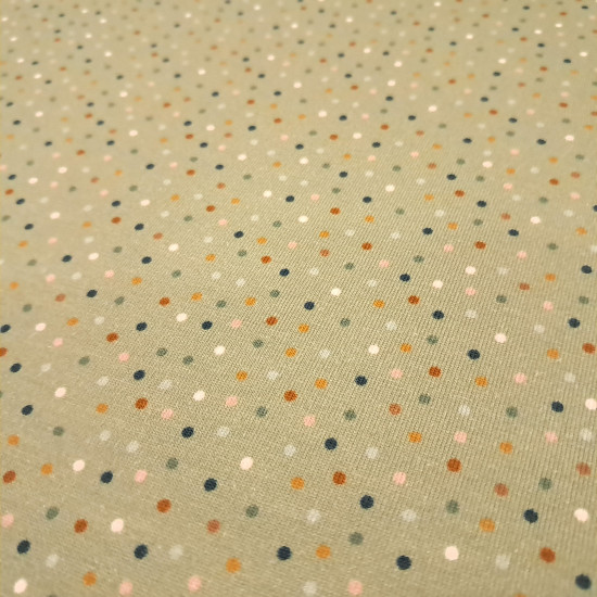Cotton Jersey Colorful Dots fabric - Cotton jersey fabric with drawings of colored dots on a greenish background. The fabric is 150cm wide and its composition is 95% cotton - 5% elastane.