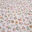 Cotton Jersey Little Spring Flowers fabric Detail of white cotton knit fabric with a small floral print in mustard, pink and green tones
