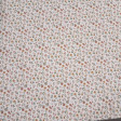 Cotton Jersey Little Spring Flowers fabric Detail of white cotton knit fabric with a small floral print in mustard, pink and green tones