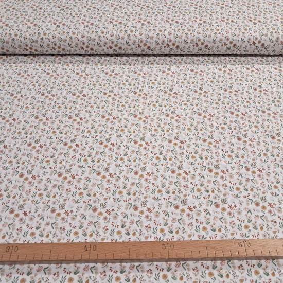 Cotton Jersey Little Spring Flowers fabric Detail of white cotton knit fabric with a small floral print in mustard, pink and green tones