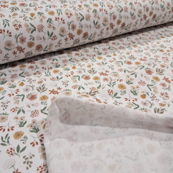 Cotton Jersey Little Spring Flowers fabric Detail of white cotton knit fabric with a small floral print in mustard, pink and green tones