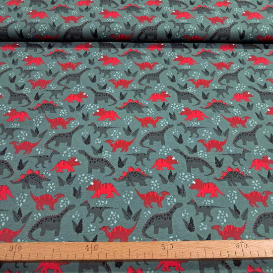 Cotton jersey fabric with red dinosaur print on moss green background
