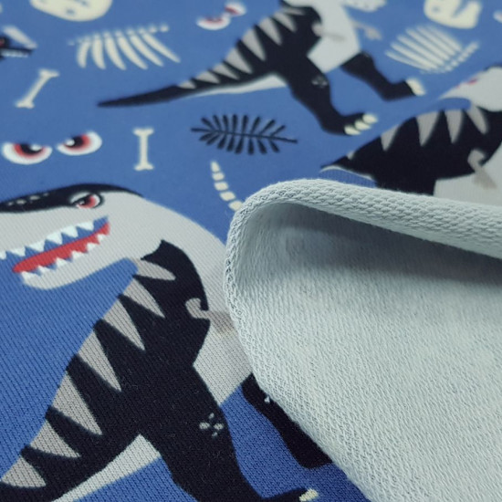 French Terry Sweatshirt Dinosaurs Roar fabric - French Terry sweatshirt fabric, ideal for spring/summer, with drawings of cool dinosaurs, skeletons, bones... on a gray-blue background. The fabric is 150cm wide and its composition 92% cotton - 8% elastane