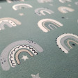 French Terry Sweatshirt Brushed Rainbow Stars fabric - Brushed French terry sweatshirt fabric featuring abstract rainbows and stars on a dark old green background. The fabric is 150cm wide and its composition is 95% cotton - 5% elastane.