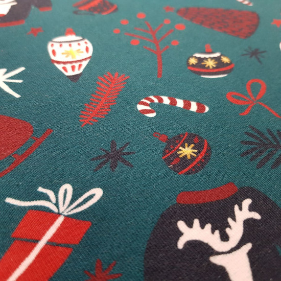 French Terry Sweatshirt Brushed Christmas Feeling fabric - French terry sweatshirt fabric with brushed inner face, with Christmas-themed drawings featuring Christmas balls, mittens, candy canes, Christmas jumpers... on a dark emerald green background. The