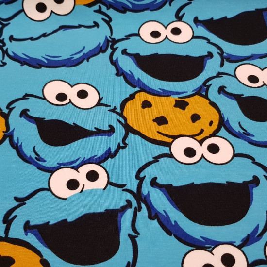 Cotton Jersey Cookie Monster fabric - Cotton jersey fabric with funny drawings of the character Triki (The Cookie Monster) from the famous Sesame Street series. The fabric measures 155cm and its composition is 92% cotton - 8% elastane