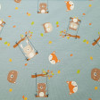 Cotton Jersey Animals Swings fabric - Cotton jersey fabric with drawings of animals such as owls, bears, bunnies, foxes... climbing on swings hanging from tree branches with leaf colors that remind us of autumn on an old green background. The fabric is 1