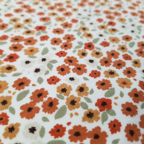 Cotton Jersey Little Flowers Rust Tones fabric - Cotton jersey fabric with drawings of tiny flowers in autumnal or tan tones (rust, orange, beige...) on a white background. The fabric is 145cm wide and its composition is 95% cotton - 5% elastane.