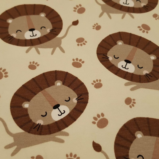 Cotton Jersey GOTS Lions fabric - Organic cotton jersey fabric (GOTS) with drawings of lions and footprints on a light background. The fabric is 160cm wide and its composition is 95% cotton - 5% elastane