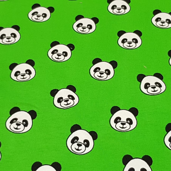 Cotton Jersey Pandas fabric - Cotton jersey fabric with drawings of panda bear faces on a green background. The fabric is 150cm wide and its composition is 95% cotton - 5% elastane