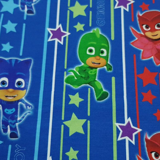 Cotton Jersey PJ Masks Stripes Stars fabric - Licensed cotton jersey fabric with drawings of the PJ Masks characters on a background with stripes and stars in various colors on a blue background. The fabric is 160cm wide and its composition is 95% cotton 