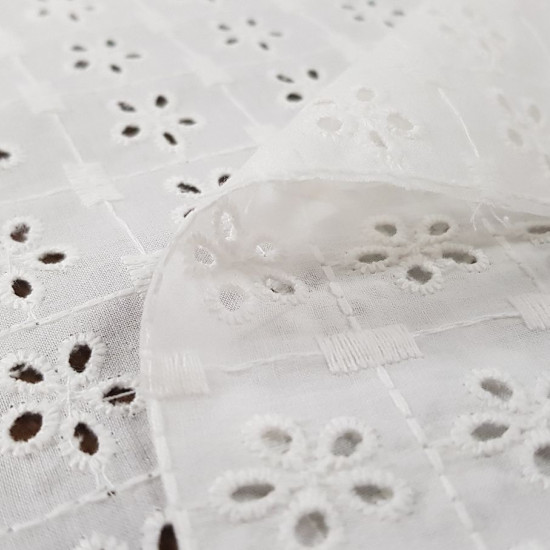 Embroidered Cotton Tiana fabric - Beautiful white embroidered and perforated cotton batiste fabric with large petal flowers. The fabric is 135cm wide and its composition is 100% cotton.