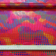 Tela Lamé Topos Multicolor - Tela de lamé brillante y un poco elástica con topos pequeños de 8mm multicolor sobre fondo rojo. Esta tela se puede usar en disfraces llamativos y también adornos y decorados. La tela mide 150cm de ancho y su composi