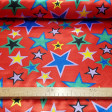 Satin Stars Colors Red Background fabric - Satin fabric with drawings of stars of various sizes and colors on a red background. An ideal fabric for flashy costumes for carnival and other parties. The fabric is 150cm wide and its composition 100% polyester