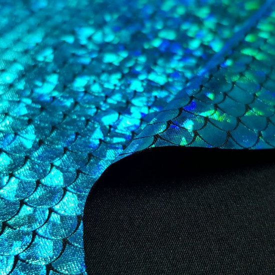 Foil Jersey Mermaid Scales fabric - Black jersey fabric with mermaid scales laminate in some colors with changing effect. It is a fabric that has elasticity and is ideal for costumes, dance clothes … The fabric is 140cm wide and its composition is