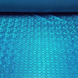 Lycra Mermaid Scales fabric - Fine stretch lycra fabric with drawings of bright mermaid scales, where blue colors predominate. The fabric is 150cm wide and its composition 97% polyester - 3% spandex