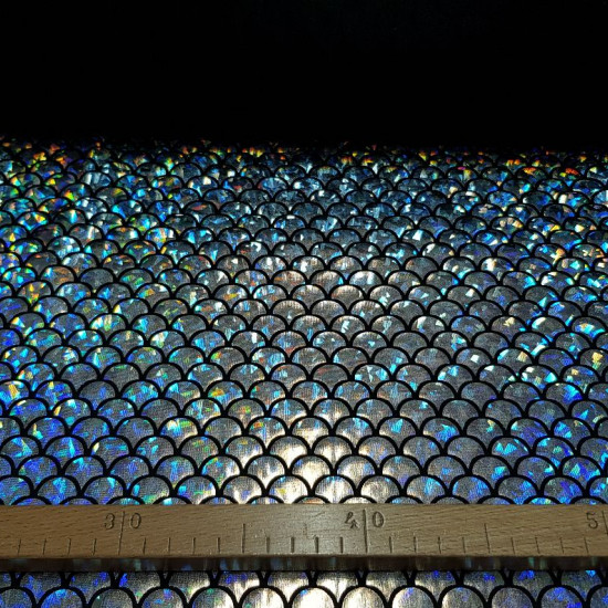 Lycra Silver Scales fabric - Elastic black lycra fabric with silver scale laminate making hologram effect. It is an ideal fabric for carnival, dance and sport dresses. The fabric is 150cm wide and its composition 92% polyester - 8% spandex.